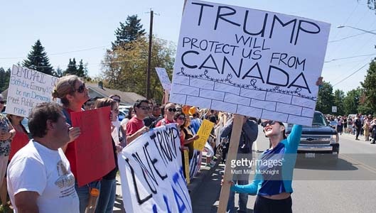 Yes, that’s a “Trump Will Protect Us From Canada” sign… BUT…